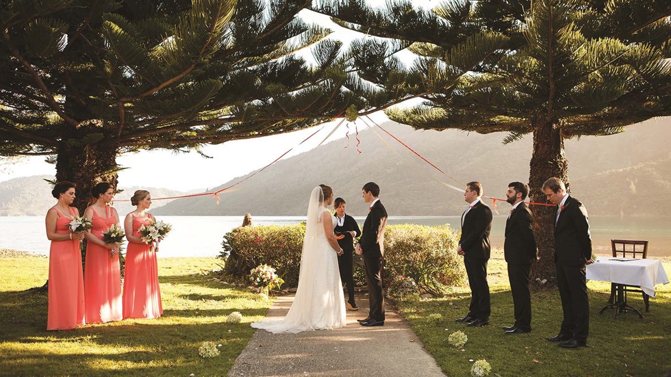 A bride and groom share their vows during a wedding ceremony at Furneaux Lodge in the Marlborough Sounds in New Zealand's top of the South Island