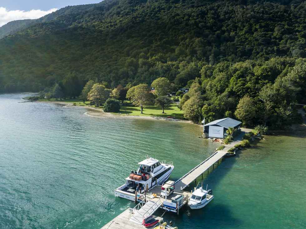 Furneaux Lodge jetty is in the foreground and Furneaux Lodge jetty in the background, in the Marlborough Sounds at the top of New Zealand's South Island.