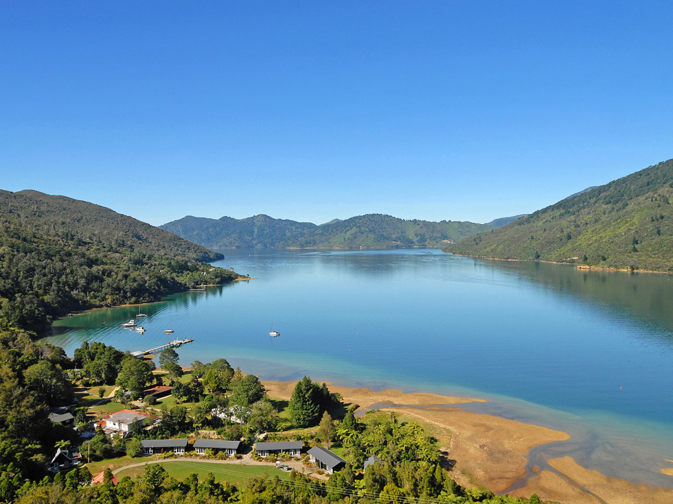 Aerial view of Furneaux Lodge out over Endeavour Inlet in the Marlborough Sounds at the top of New Zealand's South Island.