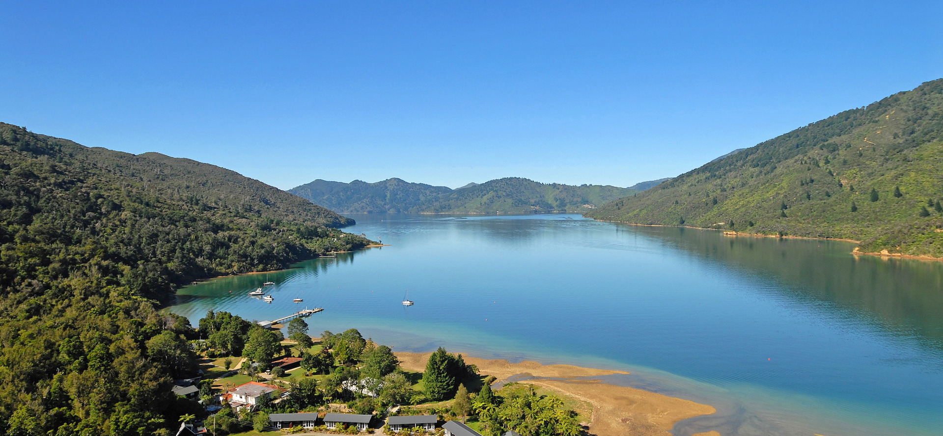 Aerial view of Furneaux Lodge out over Endeavour Inlet in the Marlborough Sounds at the top of New Zealand's South Island.