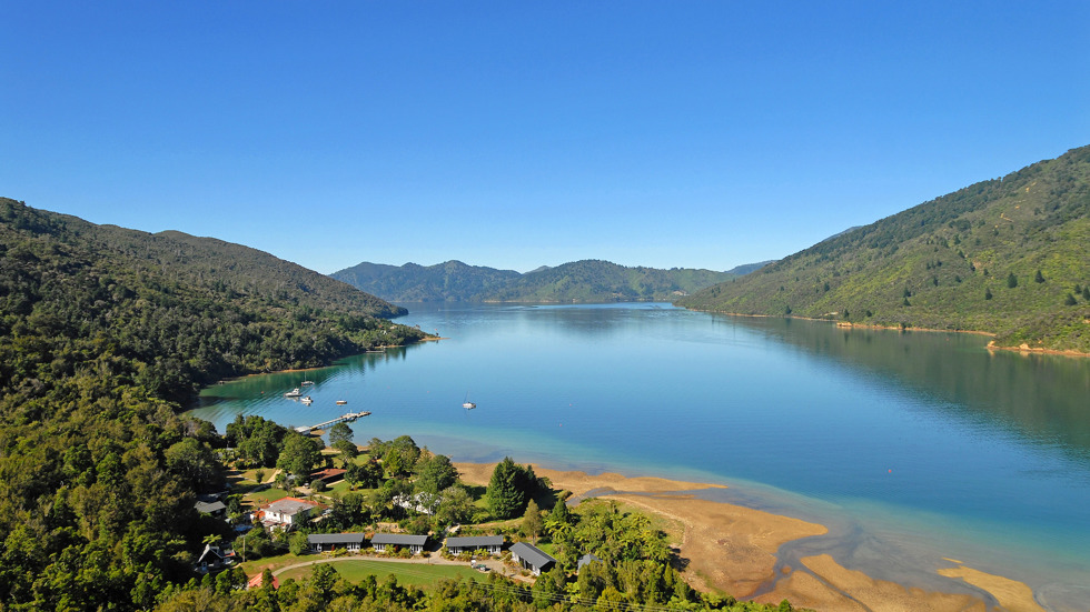 Aerial view of Furneaux Lodge out over Endeavour Inlet in the Marlborough Sounds at the top of New Zealand's South Island.
