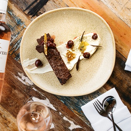 Delicious house-made brownie with cream served with a glass of Two River's Rose at the Furneaux Lodge Restaurant in the Marlborough Sounds at the top of New Zealand's South Island.