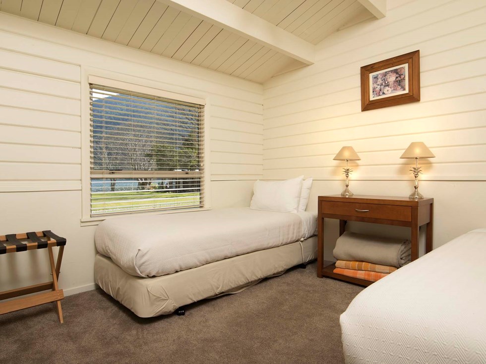 A twin room in a Cook's Cottage with two single beds at Furneaux Lodge in the Marlborough Sounds at the top of New Zealand's South Island.