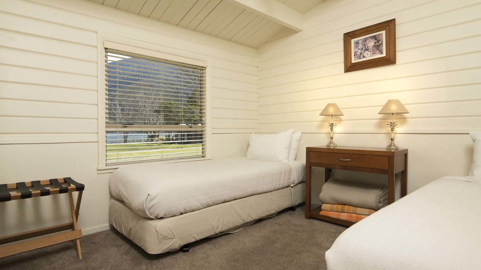 A twin room in a Cook's Cottage with two single beds at Furneaux Lodge in the Marlborough Sounds at the top of New Zealand's South Island.