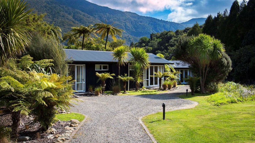 Endeavour Suites are surrounded by lush green forest and native bush at Furneaux Lodge in the Marlborough Sounds at the top of New Zealand's South Island.