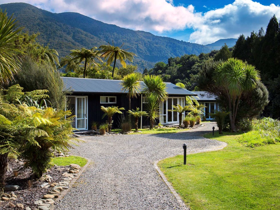 Endeavour Suites are surrounded by lush green forest and native bush at Furneaux Lodge in the Marlborough Sounds at the top of New Zealand's South Island.