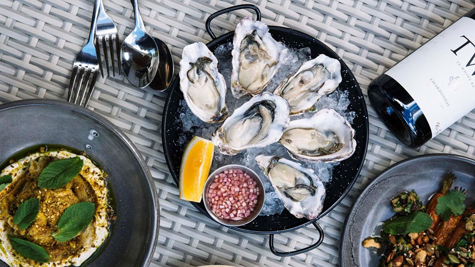 Choose from sharing plate options such as fresh oysters, gourmet hummus dish and roast carrots served with Te Whare Ra Chardonnay Furneaux Lodge Restaurant in the Marlborough Sounds at the top of New Zealand's South Island.